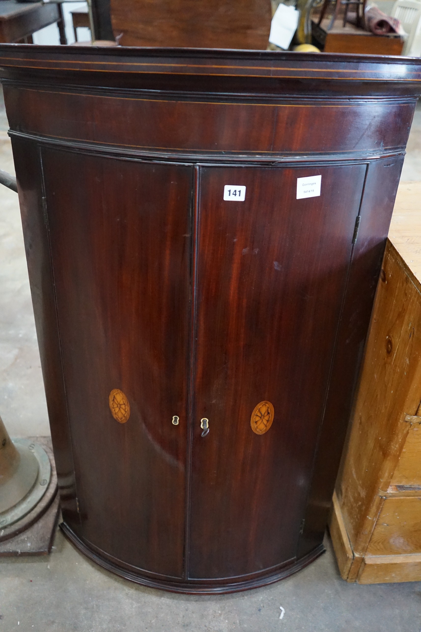 A George III inlaid mahogany bow front hanging corner cabinet, width 74cm, depth 54cm, height 117cm